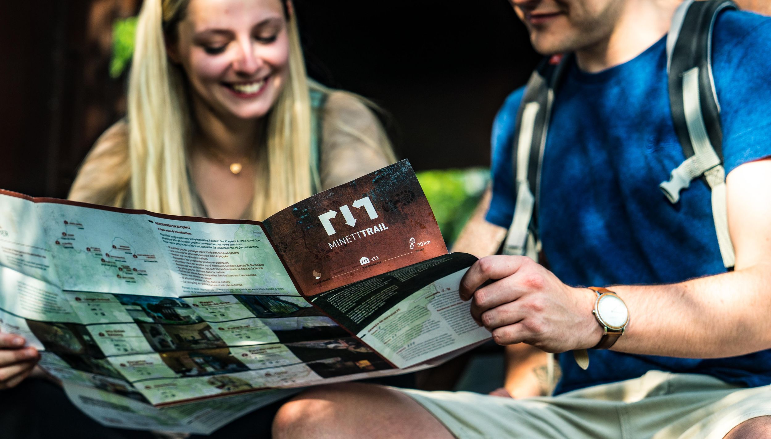 Deux randonneurs à la découverte de la région avec la carte du Trail